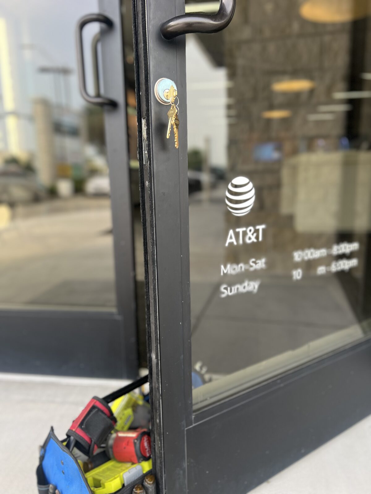 Locksmith rekeying a commercial storefront door lock cylinder in Houston