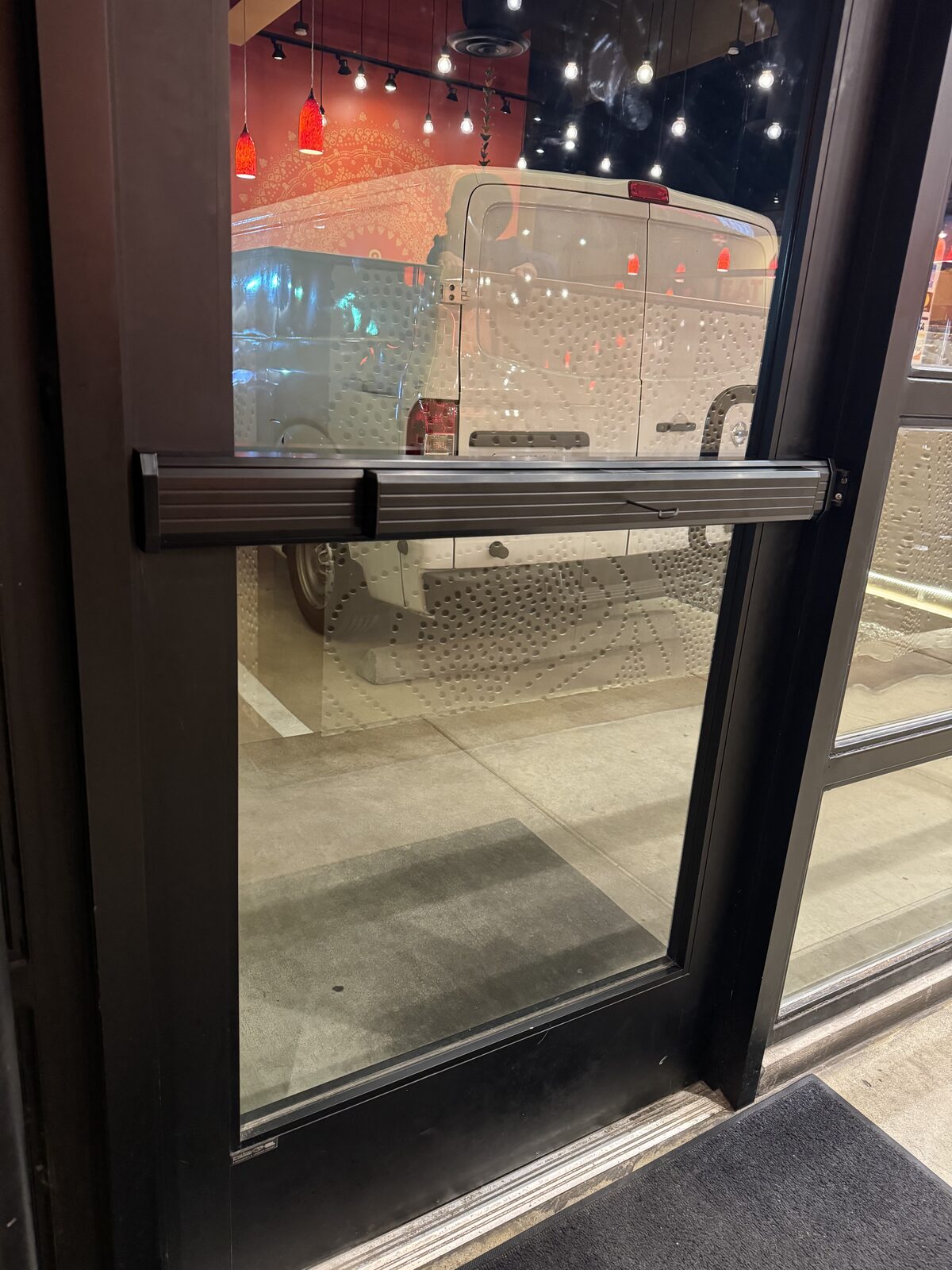 Panic bar exit device on a restaurant glass door
