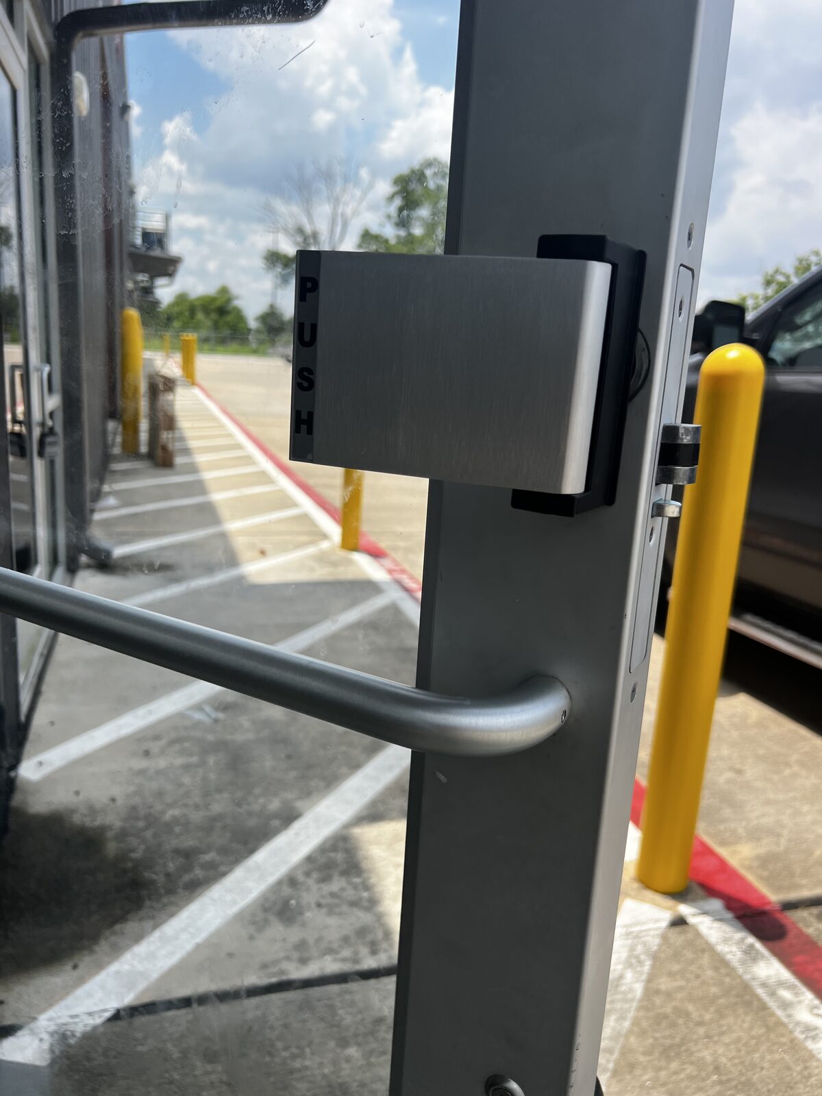 Push paddle exit hardware on an aluminum storefront door
