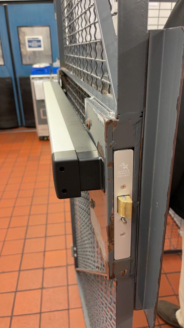 Adams Rite deadlatch and push bar on a warehouse cage door