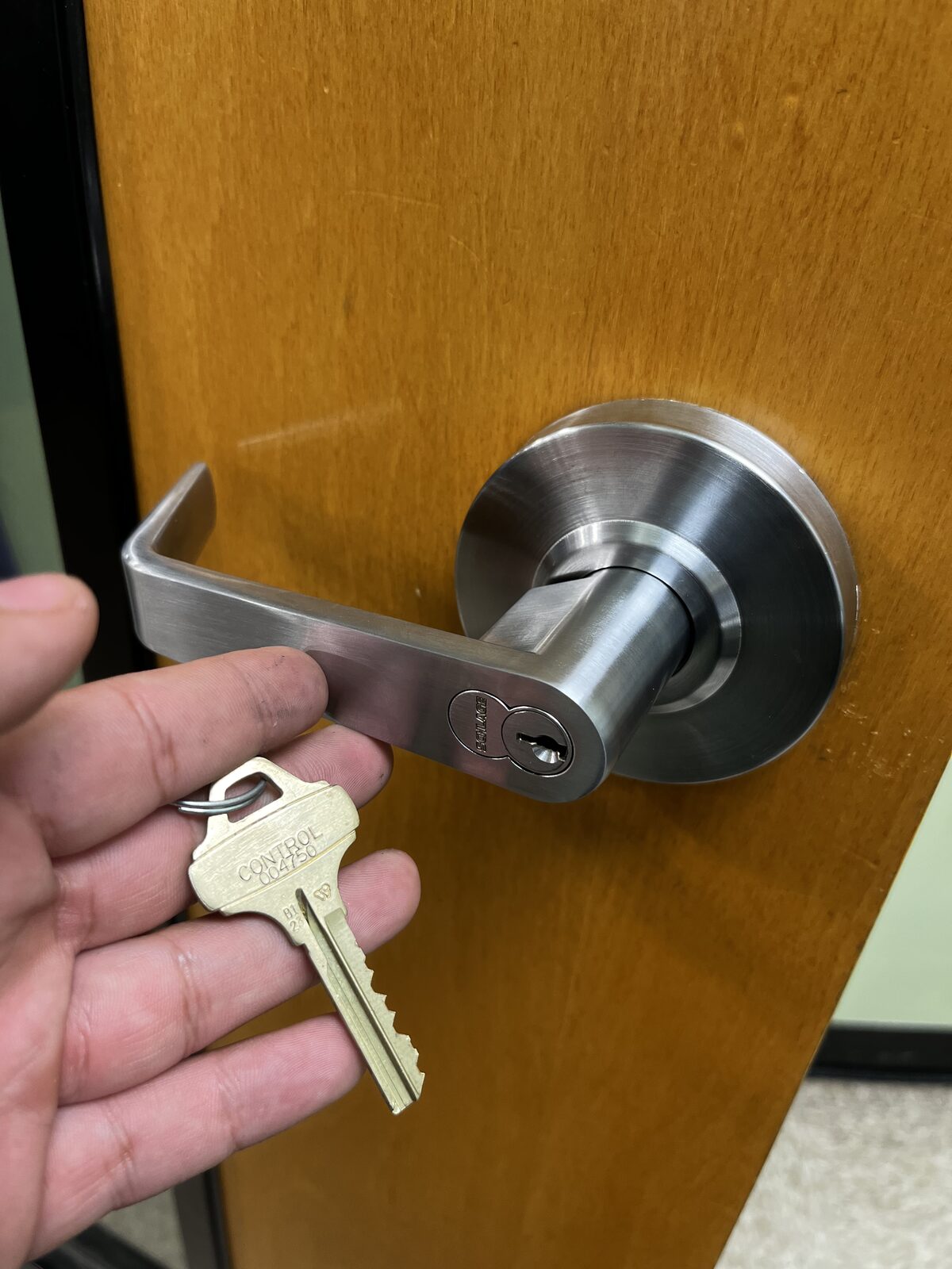 Locksmith holding control key after installing a Schlage lever lock