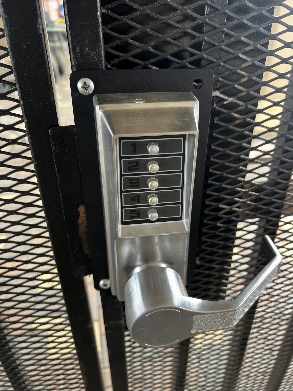 Mechanical keypad lever lock installed on a pedestrian gate