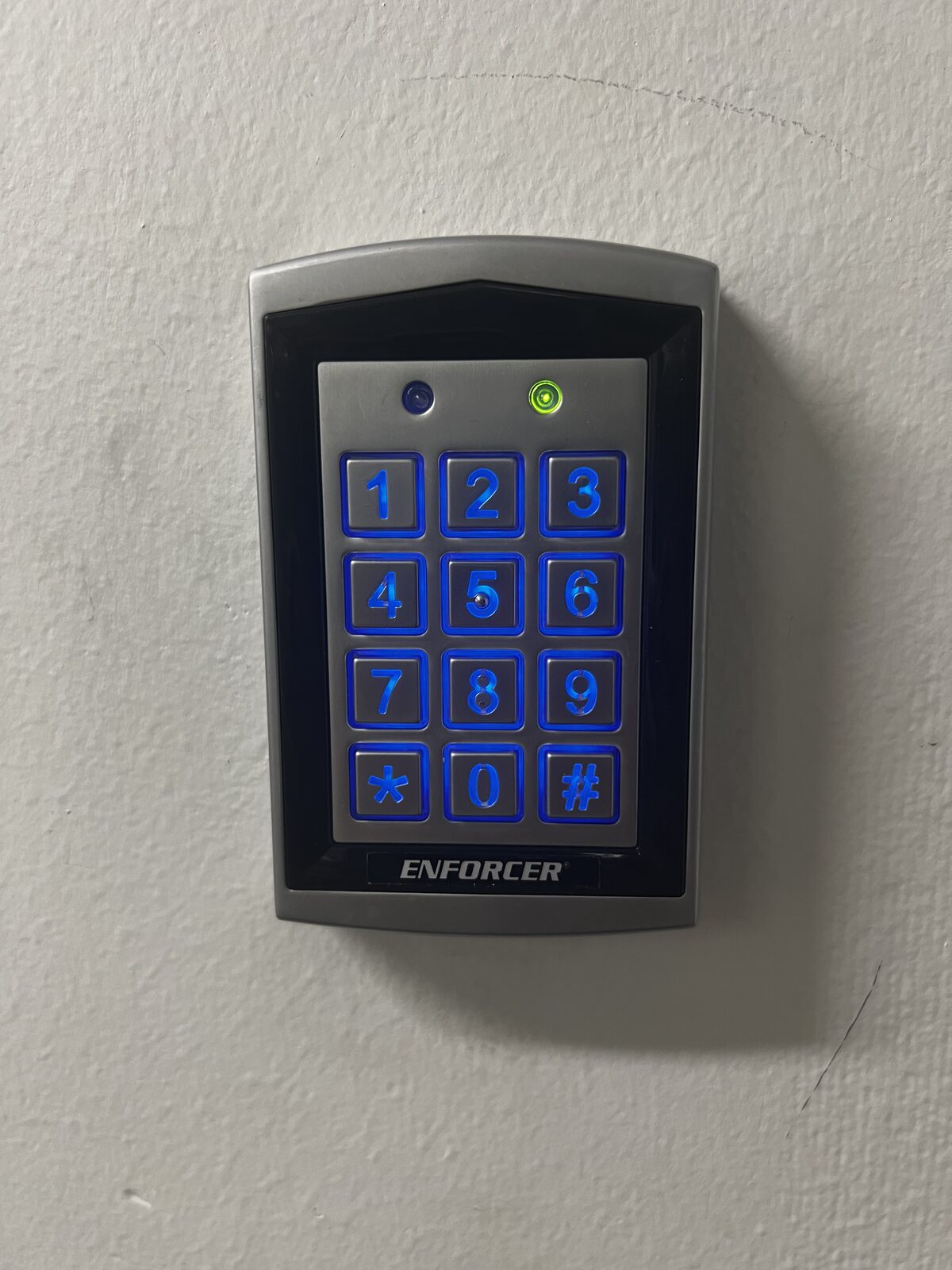Backlit stand-alone access control keypad installed on a wall in Houston