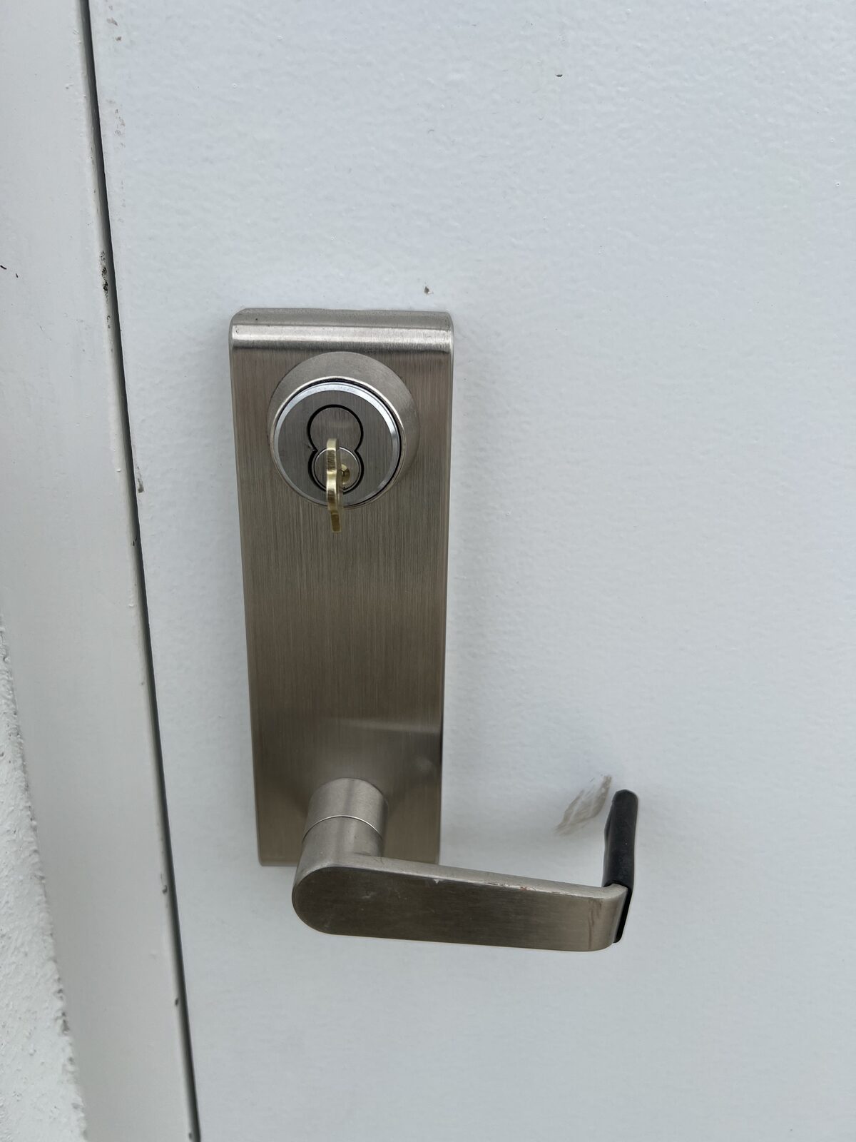 Keyed lever trim for an exit device on a commercial metal door in Houston