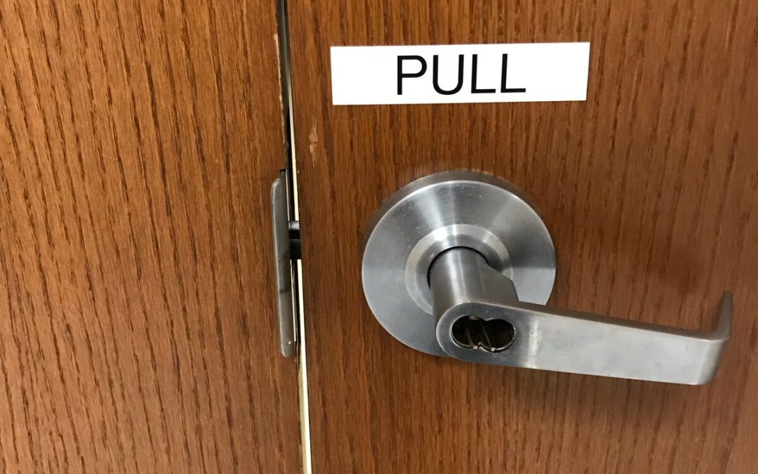Commercial lever lock with the interchangeable core removed on a wood door in Houston