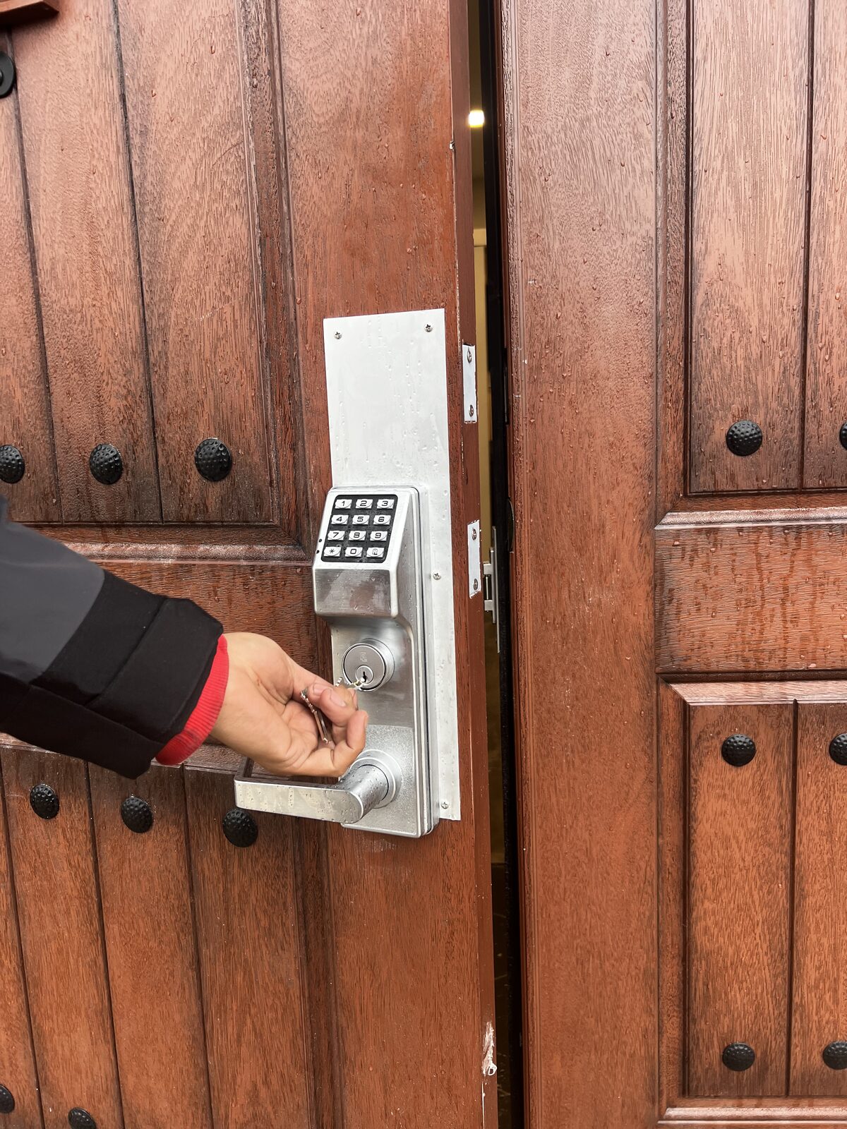 Keypad lever lock with key override on a wood double door in Houston