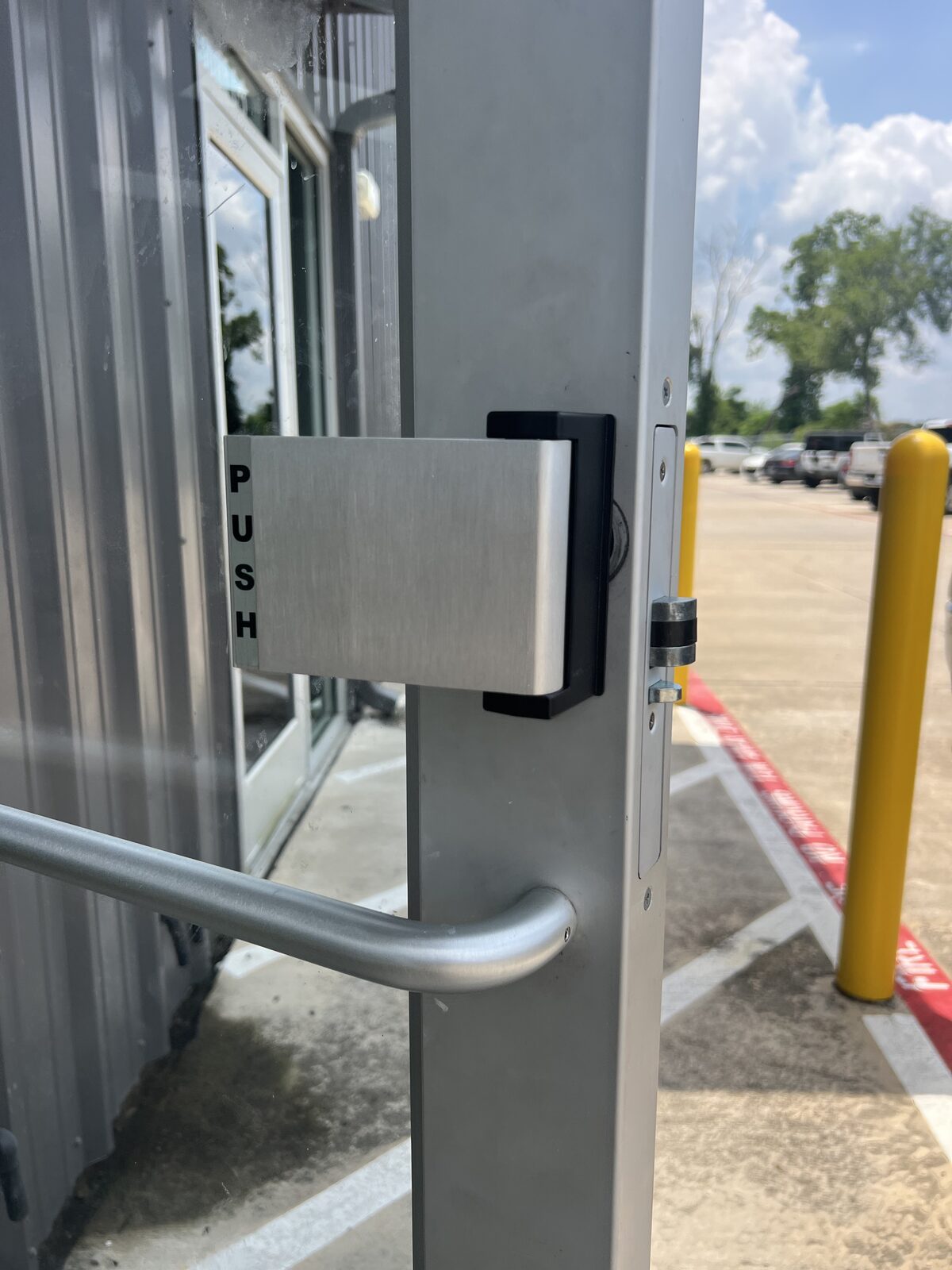 Push paddle and pull handle on an aluminum storefront door in Houston